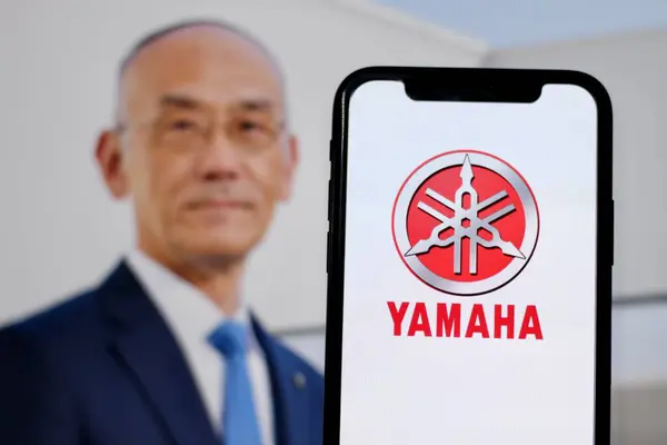 stock image In this photo illustration,the logo of Yamaha,with CEO Yoshihiro Hidaka in the background.indonesia - June 26th 2024.