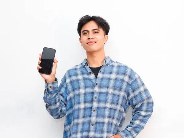 stock image young asian man posing with smartphone in studio