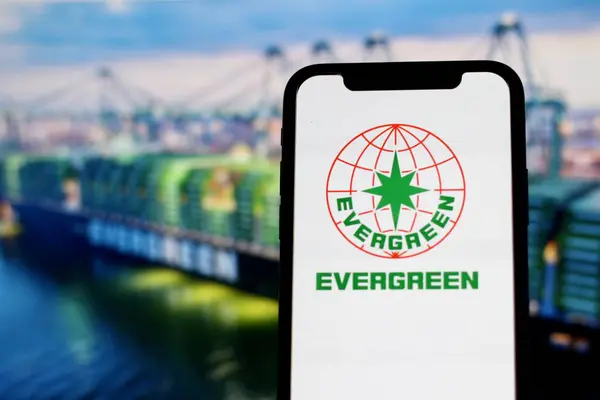 stock image close up view of the smartphone with Evergreen logo, organizational designation used by a Taiwan-based conglomerate of shipping, transportation, and associated service companies.