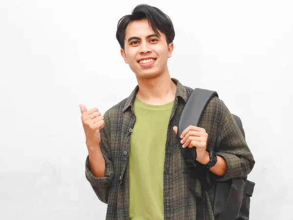 Stock image Asian man in green flannel shirt posing with backpack on white background  