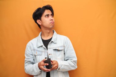 Zavallı Asyalı adam boş cüzdan tutuyordu. Asyalı adam boş cüzdan tutuyordu. Yan tarafa bakıyordu..