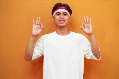 Endonezya 'nın 17 Ağustos' taki bağımsızlık gününü kutlayan mutlu Endonezyalı adam gülümseyen dostça bir jest ve mükemmel bir sembol ile 