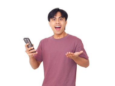 Mutlu Asyalı genç adam akıllı telefonu açık ağızla tutuyor ve elleri kaldırıyor. Heyecanlı, şaşırmış tepkiler gösteriyor..