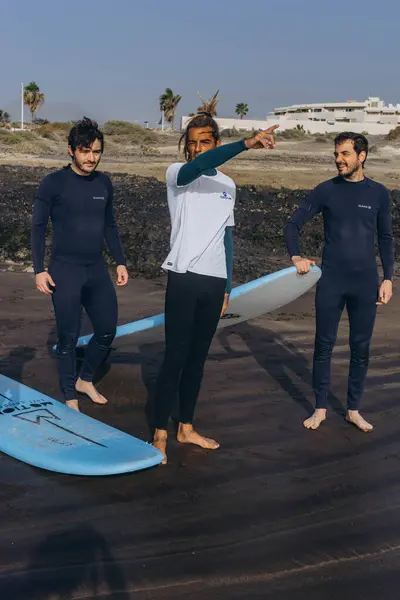 stock image Island of Tenerife-December 16, 2023: Coach show how to surf to the group of surfers. High quality photo