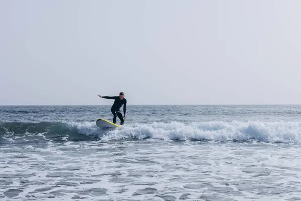 Stock image  young guy surfers going for surfing in the ocean. . High quality photo