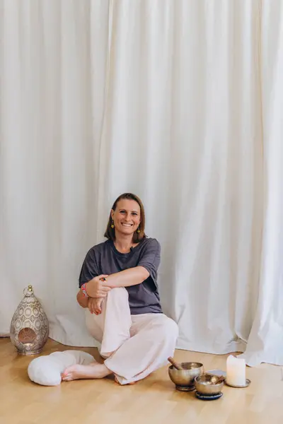 stock image A happy woman after a breathing and singing bowl practice. High quality photo