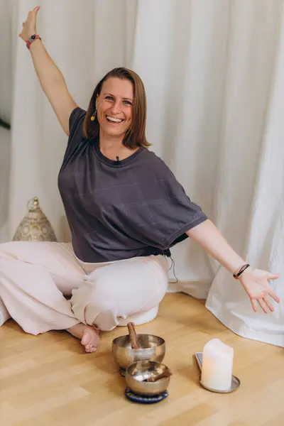 stock image A happy woman after a breathing and singing bowl practice. High quality photo