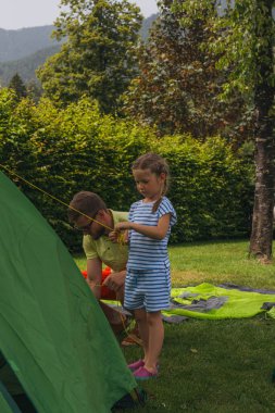 Happy family father and daughter in camping. summer holidays in the Alps. High quality photo clipart