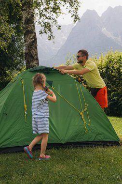 Happy family father and daughter in camping. summer holidays in the Alps. High quality photo clipart