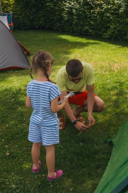 Happy family father and daughter in camping. summer holidays in the Alps. High quality photo clipart