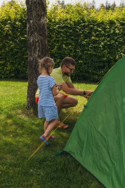 Happy family father and daughter in camping. summer holidays in the Alps. High quality photo clipart