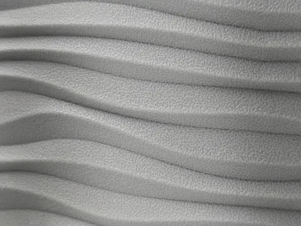 Dalga desenli ve dokulu kaplamalı soyut gri yüzey. Modern tasarım ögesinin ya da dekoratif arka planının yakın çekimi. Minimalist ve endüstriyel tarzda.
