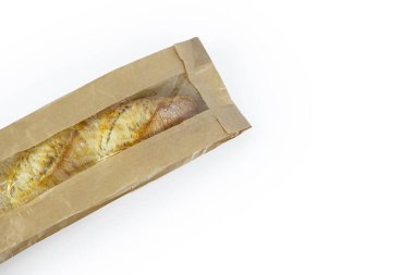 Kahverengi bir kesekağıdında taze pişmiş Fransız ekmeği. Beyaz bir arka planda izole edilmiş. Bir somun beyaz ekmek. Çevre dostu sürdürülebilir kahverengi kağıt torbaya sarılmış. Uzayı kopyala kırpma yolu ile.