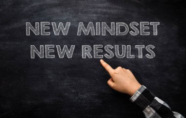 Phrases New Mindset and New Results pointed by person on black chalkboard. Business mindset to understand and follow strategies and action plans