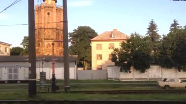 Village houses, forest and railway from the train window