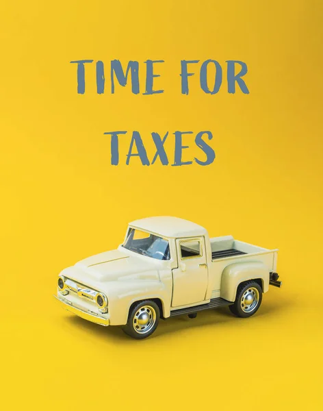 time for taxes on yellow background. High quality photo