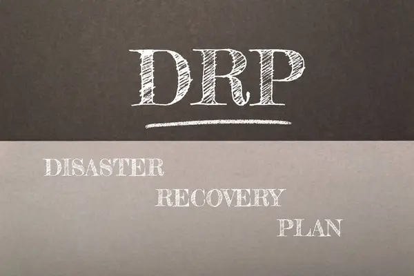 stock image A chalkboard with the words Disaster Recovery Plan written on it. The words are in white and the background is in black