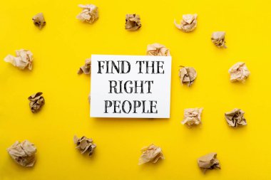 A yellow background with a white sign that says find the right people. The sign is surrounded by crumpled paper, which gives the image a sense of chaos and disorganization clipart