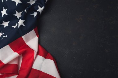 Siyah arka planda kırmızı ve beyaz bir Amerikan bayrağı asılı. Bayrak resmin ana odak noktasıdır ve siyah arkaplan bir karşıtlık hissi yaratır ve bayrağın renklerini vurgular