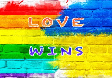 Colorful wall with the words love wins written on it. The colors of the rainbow are splashed across the wall, creating a vibrant and joyful atmosphere. The message of love clipart