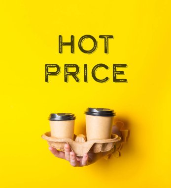 Person holding two cups with the words hot price written on the background. The image has a playful and lighthearted mood, as the person is holding the cups as if they are being offered for sale clipart