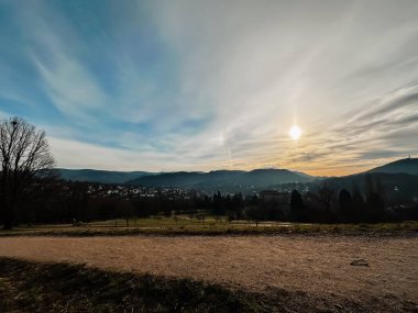 Arkasında büyük bir dağ olan güzel bir manzara. Gökyüzü açık ve mavidir birkaç bulutla