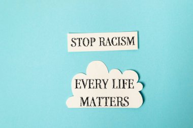 Blue background with two white stickers that say Stop Racism Every Life Matters. The message is clear and straightforward, urging people to take action against racism clipart