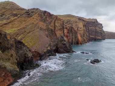 Madeira 'daki Sao Lourenco yarımadası hava aracı görüntüsünden. Ponta de So Loureno. Mavi okyanus dalgalı volkanik kayalar ve drone manzaralı bulutlar..