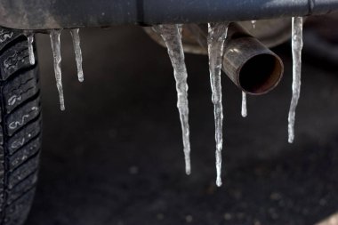icicle at the muffler of a car symbol for ice rain clipart