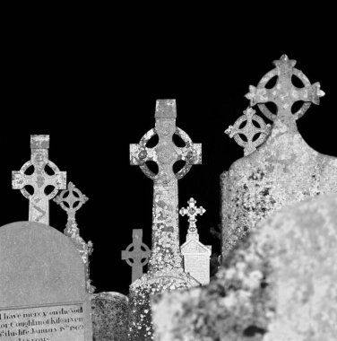 several celtic grave crosses in a cemetery clipart