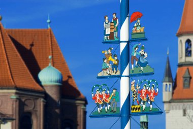 Munich, Bavaria, Germany; July 2nd 2007, Maypole on the Viktualienmarkt, in background the tower of the Old Town Hall clipart