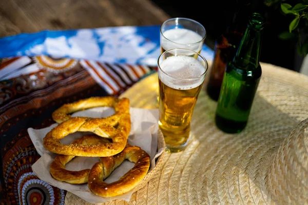 Celebration Of The Famous German Beer Festival Oktoberfest. Original Bavarian Oktoberfest Pretzels In A Basket With Beer From Germany On Wooden Board.