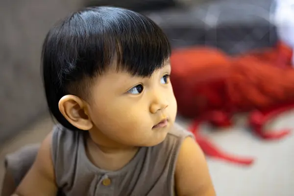 stock image Little boy sitting in bedroom. 