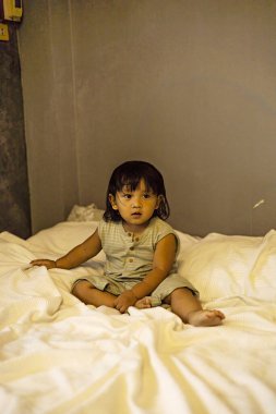 Çocuk yatak odasındaki yatakta oynuyor, yemek ve içeceklerde reklam ve duvar kağıdı sahnesi için arka plan.