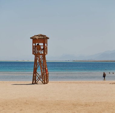 Soma Bay, Egypt - life guard tower at the beach with people in the water clipart