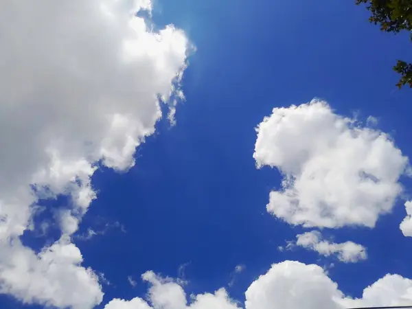 Cotton balls cloud against blue sky background.