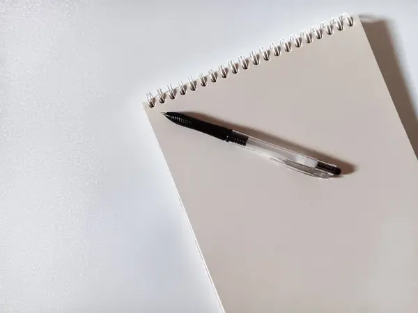 stock image Top view of blank page of a notebook and black pen isolated on white background. Flat lay.