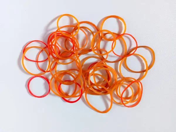 Beyaz zemin üzerinde kırmızı ve sarı lastik bant izole.