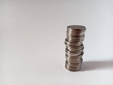 Stack of Indonesian money 1000 rupiah coins isolated on white background. clipart