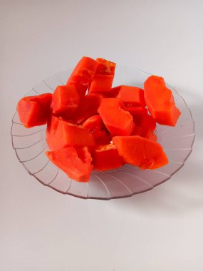 Sweet fresh ripe papaya fruit slices on transparent plate isolated on white background. clipart