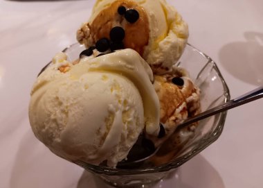 Affogato, üzerine beyaz arka planda izole edilmiş bir camın üzerine sıcak espresso dökülmüş vanilyalı dondurmanın İtalyan tatlısıdır..