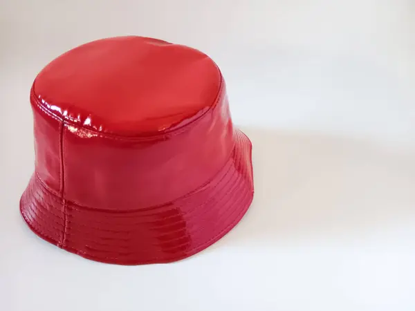 Beyaz arka planda izole edilmiş kadınlar için kırmızı yağmur kovası şapkası. 