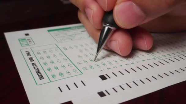 Hispanic Male Hand Filling Out Writing Exam Test Form High — Stock Video
