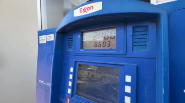 Editör: Mar 18 2025 Austin, Teksas ABD - Yakıt Pompası Exxon İstasyonu Galonların Dağıldığını Göstermektedir. Yüksek kalite 4k görüntü
