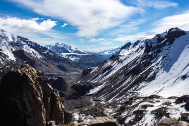 peak of the Andes mountain range where a lot of snow falls and there are many kilometers of mountains in front clipart