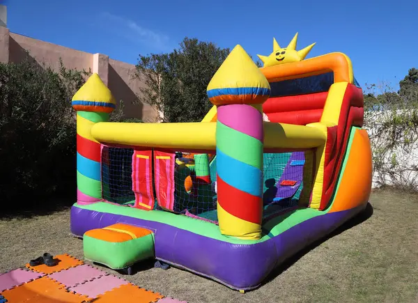 Inflatable castle. Outdoor game for children. Fun for boys and girls. Children\'s birthday. Fun in amusement park. Childhood. Children\'s party.