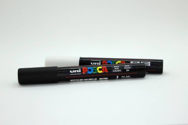 Uni Posca brand fibers. Fibers that write on any type of surface without erasing. School, artistic and office supplies on white isolated background. clipart