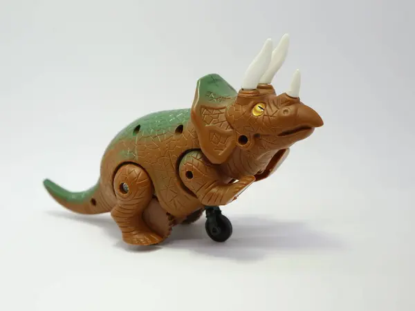 Toy dinosaur. Plastic friction dinosaurs. Toy for young children. Triceratops. Jurassic time.