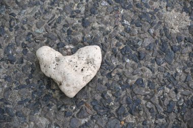 Heart of stone. Concept of toughness, no heart and no love. Heart-shaped marine stone. Fiend. cold blooded, disheartened, insensitive, cruel, ruthless. Texture. clipart