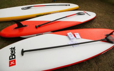 Paddle boarding. Paddle surf boards and paddles. Best and Mistral brand sports accessories. Water sport for sea and lakes. Rowing and balance sport. Individual competition sport. Outdoor water clipart